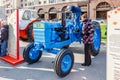 Moscow, Russia - October 08, 2019: Visitors of the traditional festival Golden Autumn near blue soviet wheel tractor TTZ T-28Kh4M
