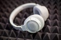 Moscow, Russia - October 04, 2019: White wireless overhead monitor headphones JBL Tune lie on a dark foam rubber noise canceling