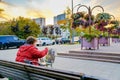 Moscow. Russia. October 1, 2020 A woman artist paints a picture sitting on a bench on a city street. Autumn evening