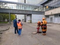 Moscow. Russia. October 7, 2020. Workers of Mosvodokanal in orange uniforms and protective helmets check the pipes