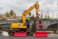 MOSCOW, RUSSIA - OCTOBER 24, 2017: Yellow wheel excavator Hyundai, working in urban environment next to the hotel `Ukraine`.