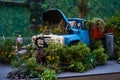 Moscow, Russia - 30.07.2022: An old blue truck filled with a variety of plants and blooms. Flower bed in Moscow, Russia. Royalty Free Stock Photo