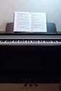 An open book of sheet music on the piano. A composition of the sheet music and the piano keyboard. Royalty Free Stock Photo