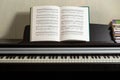 Open notes of Chopin`s Etudes stand on a brown piano. Royalty Free Stock Photo