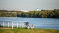 People on the nature. little girl having a picnic with little brother in a stroller on the river bank in the park. Royalty Free Stock Photo