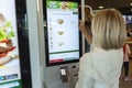 Moscow, Russia, 08/11/2019: People order food on display at McDonald`s