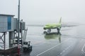 Plane prepares to take passengers to airport in difficult weather conditions Royalty Free Stock Photo