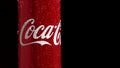 Moscow, Russia - 14 04 2020: A red metal can with a volume of 0.33 spins on a black background. Coca Cola sign in frame Royalty Free Stock Photo