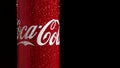 Moscow, Russia - 14 04 2020: A red metal can with a volume of 0.33 spins on a black background. Coca Cola sign in frame Royalty Free Stock Photo