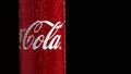 Moscow, Russia - 14 04 2020: A red metal can with a volume of 0.33 spins on a black background. Coca Cola sign in frame Royalty Free Stock Photo