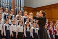 children`s choir and conductor perform on stage. Royalty Free Stock Photo