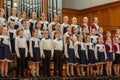 Children`s choir and soloists on stage before the start of the performance.