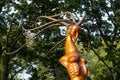 Bronze sculpture `Aphrodite`, a symbolic female figure against the background of tree leaves