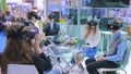 Group of teenagers using virtual reality headset at technology show