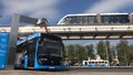 Moscow, Russia-September 2017:The concept of urban transport .Blue electric bus at the charging station.Modern train passing on th Royalty Free Stock Photo