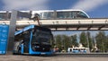 Moscow, Russia-September 2017:The concept of urban transport .Blue electric bus at the charging station.Modern train passing on th Royalty Free Stock Photo