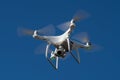 MOSCOW, RUSSIA - 24 September, 2017: DJI Phantom 4 pro quadcopter drone flying with a camera against blue sky. Royalty Free Stock Photo