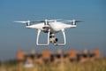 MOSCOW, RUSSIA - 24 September, 2017: DJI Phantom 4 pro quadcopter drone flying with a camera against blue sky.