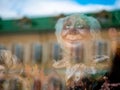 Dolls depicting fairytale heroes in a window of a Moscow Puppet Theater. The figure of a old woman head. Buildings opposite