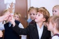 Moscow, Russia, September 2015. An elementary school student in a science class gives a teacher a leaf of a tree. Bright emotions