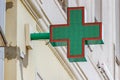 Moscow, Russia - September 13, 2019: Green cross pharmacy sign close-up. LED green cross installed on the wall above entrance to Royalty Free Stock Photo