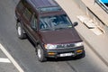 Moscow, Russia - September 27, 2022: Japanese brown and burgundy Nissan Pathfinder R50 car driving on the road Nissan Terrano old