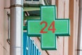 Moscow, Russia - September 13, 2019: LED green cross with numeric 24 above entrance to the pharmacy. Symbol of 24-hour pharmacy Royalty Free Stock Photo