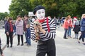 A male mime with a soft raccoon toy at the Bright people festival in Gorky Park on city Day