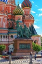 Moscow, Russia - September 30, 2018: Monument to Minin and Pozharsky against colored domes of St. Basils Cathedral on Red square i Royalty Free Stock Photo