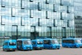 Moscow, Russia, September 15, 2020. Parking of blue minibuses against the backdrop of a glass skyscraper
