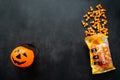 Moscow, Russia, September 2021: Plastic pumpkin basket, candy corn Brachs spilled out of the pack. Halloween sweets. Copy space Royalty Free Stock Photo