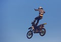 Moscow / Russia - September 23 2017: Pro motocross rider riding fmx motorbike, jumping performing extreme stunt. Professional