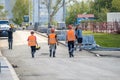 Moscow. Russia. September 06, 2020 Rear view of a group of construction workers wearing orange vests and safety helmets