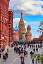 Moscow, Russia - September 30, 2018: Tourists walk on Red Square near wall of State Historical Museum on a background of St. Basil Royalty Free Stock Photo