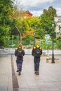 MOSCOW, RUSSIA - SEPTEMBER 14, 2021 Two DHL couriers postmen delivering parcels order on scooters, express mail services