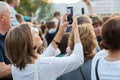 Unidentified woman filming scene by mobile phone during a concert dedicated Moscow city day on September 9, 2019