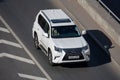 Moscow, Russia - September 27, 2022: White Japanese SUV Lexus LX driving down the road J200 Toyota Land Cruiser 200 LX570 500d