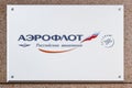 Moscow, Russia - September 13, 2019: White metal signboard of russian airline Aeroflot close-up on the wall at the entrance to the