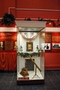 Museum exhibits behind glass. Old antique books are stacked, next to a telescope. Royalty Free Stock Photo