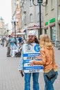 Moscow, Russia, 2015.07.09 A street advertiser is talking to a woman. Advertisement for the Aquarium History Museum on a