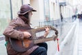 12-10-2019, Moscow, Russia. A street musician in a leather jacket and hat plays a makeshift string instrument, two necks on the Royalty Free Stock Photo