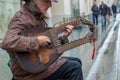 12-10-2019, Moscow, Russia. A street musician with an unusual guitar plays passers-by music in the style of Russian folk. The only Royalty Free Stock Photo