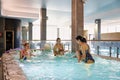 Moscow, Russia, 01.02.2019, three mothers with three babies bathe in a jacuzzi, sauna, pool Royalty Free Stock Photo