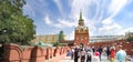 Tourist people walking near Trinity and Kutafya towers of Moscow Kremlin