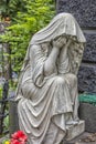 Sculpture of a grieving woman on a grave