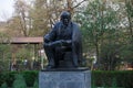 MOSCOW / RUSSIA - 20/04/2019 vertical close up shot of a black forged copper sculpture of Vladimir Lenin sitting with a notebook