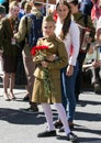 Victory Day in Moscow. Beautiful girl in military uniform with red flowers on Victory Day. Royalty Free Stock Photo