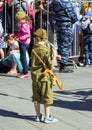 Victory Day in Moscow. A boy wearing military uniform with toy automat on parade of Victory Day.