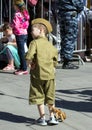 Victory Day in Moscow. A boy wearing military uniform with toy automat on parade of Victory Day.