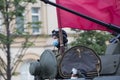 Tankman soldier on a gun turret of a Russian army military armored vehicle tank at Sadovaya street garden Ring